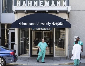 A person exits Hahnemann University Hospital in Philadelphia, Wednesday, June 26, 2019. The owner of hospital has announced it will close in September because of what the company calls 