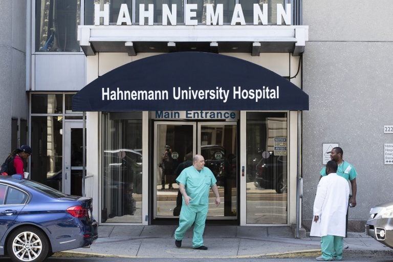 A person exits Hahnemann University Hospital in Philadelphia, Wednesday, June 26, 2019. The owner of hospital has announced it will close in September because of what the company calls 