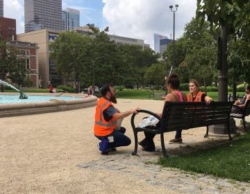 Pre-heat wave, Kevin Riordan (left) and Carrie Wagner offer services to a person experiencing homelessness. MICHAELA WINBERG / BILLY PENN