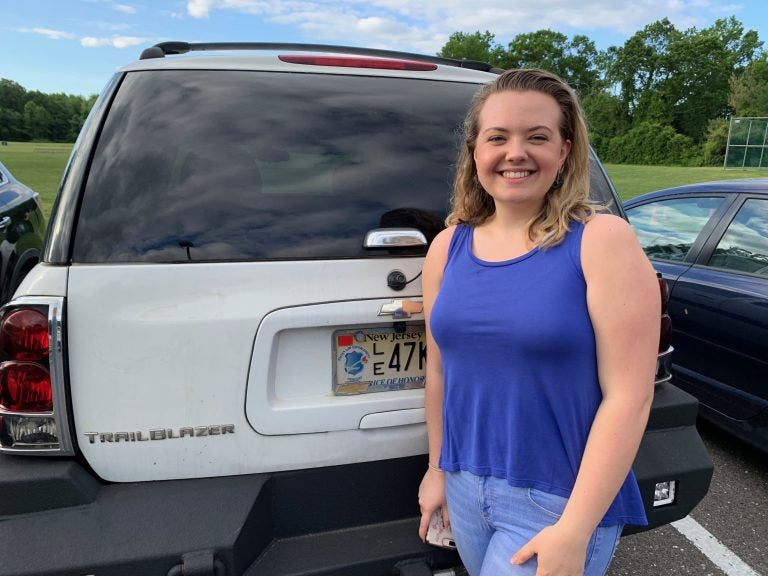 Shelby Deibler, 17, uses the state-mandated red tags, even though she’s wary about the idea. She said she would rather be cautious and wants to avoid paying the fine if she happens to be pulled over. (Andrew Rowan for WHYY)
