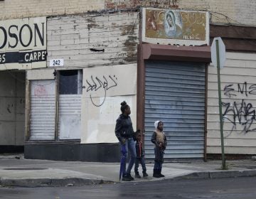 In this Thursday, Nov. 3, 2016, photo, pedestrians in Newburgh, an upstate New York city already struggling with poverty and violent crime were told to have their blood tested for a toxic chemical because its water supply was found to have high levels of the cancer-linked chemical PFOS that was used for firefighting at the nearby military base. (AP Photo/Mike Groll)