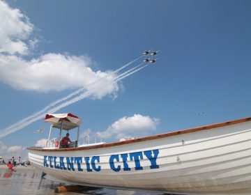 The U.S. Air Force Thunderbirds Air Demonstration Squadron starts their show over the beaches of Atlantic City, N.J. as lifeguard Ryan McCline watches bathers on Aug. 13, 2014. (U.S. Air National Guard photo by Tech. Sgt. Matt Hecht)