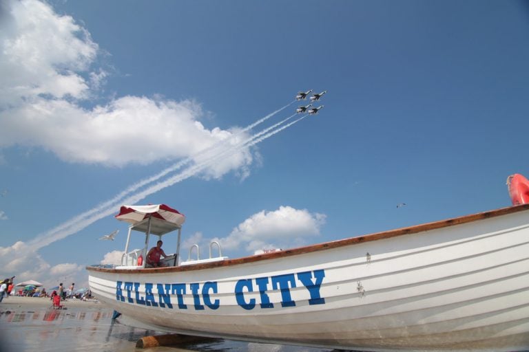 The U.S. Air Force Thunderbirds Air Demonstration Squadron starts their show over the beaches of Atlantic City, N.J. as lifeguard Ryan McCline watches bathers on Aug. 13, 2014. (U.S. Air National Guard photo by Tech. Sgt. Matt Hecht)