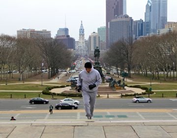 Rocky impersonator John Monforto runs up the steps of the Philadelphia Museum of Art. (Emma Lee/for NewsWorks)