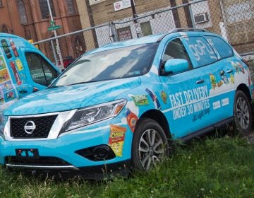 A small fleet of GoPuff delivery vehicles, parked outside their Philadelphia headquarters. (Kimberly Paynter/WHYY)