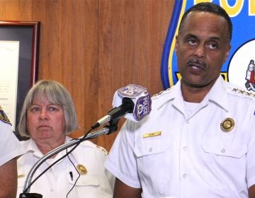 Interim Philadelphia Police Commissioner Christine Coulter stands behind former Commissioner Richard Ross during a press conference addressing racist Facebook posts on July 18, 2019. (Emma Lee/WHYY)