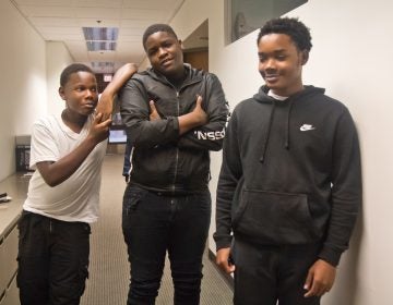 Nasir Holloman (left), Kyree Keels (center) and Kadir Douglass (right) opened a phone repair business at their school. (Kimberly Paynter/WHYY)