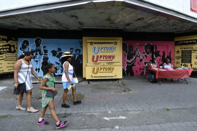 People walk past the Uptown Theater on the 2200 block of North Broad Street. Visitors had the chance to see the theater from the inside during the annual Philly Free Streets event. (Bastiaan Slabbers for WHYY)