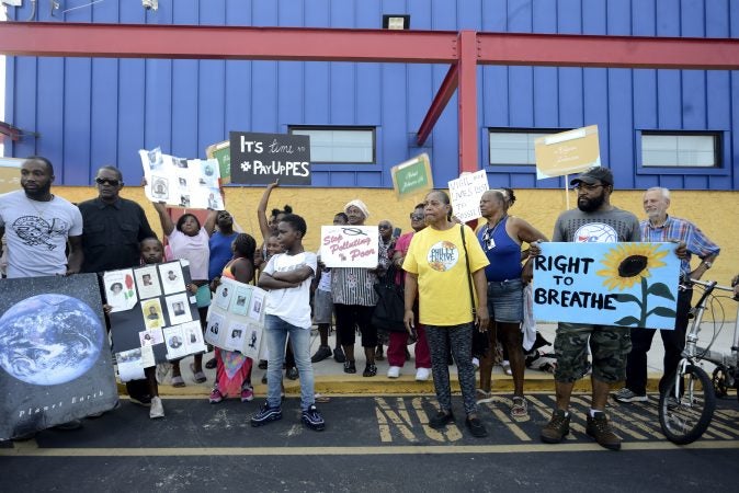 Fence-line neighbors and activists with Philly Thrive protest outside, ahead of the first public meeting of the Philadelphia Energy Solutions refinery advisory group held at Preparatory Charter School, on Tuesday. (Bastiaan Slabbers for WHYY)