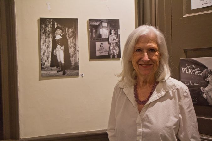 Dee Dee Bowman is the Collections Chair of the Parry Mansion Museum in New Hope. She stands in front of a photo of a young Liza Minelli on stage at the Bucks County Playhouse. (Kimberly Paynter/WHYY)