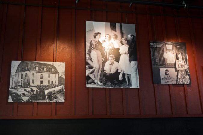 Historic images of the Bucks County Playhouse (left), Robert Redford on stage (center) and Liza Minelli (right) hang in The Deck, a restaurant attached to the Bucks County Playhouse in New Hope, Pa. (Kimberly Paynter/WHYY)