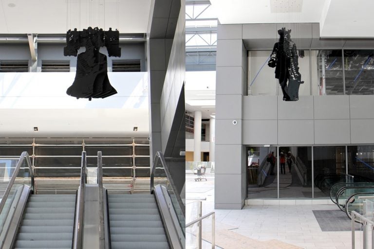 A hanging sculpture of the Liberty Bell by perceptual artist Michael Murphy becomes William Penn when viewed from a different angle. (Emma Lee/WHYY)