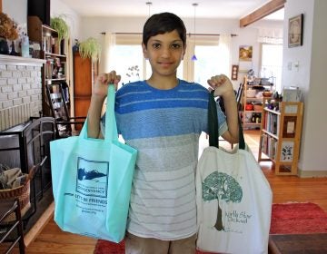 Kiran Schatz, 12, carries his school supplies home in reusable bags. The West Chester student and his classmates worked to promote legislation that would ban the use of disposable plastic bags in their town. (Emma Lee/WHYY)
