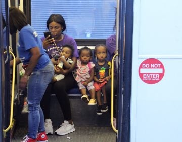 Children from the Precious Babies daycare are evacuated on SEPTA buses from the scene of a mass shooting and standoff with police. (Emma Lee/WHYY)