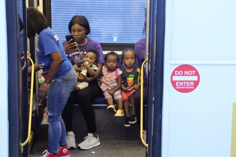 Children from the Precious Babies daycare are evacuated on SEPTA buses from the scene of a mass shooting and standoff with police. (Emma Lee/WHYY)