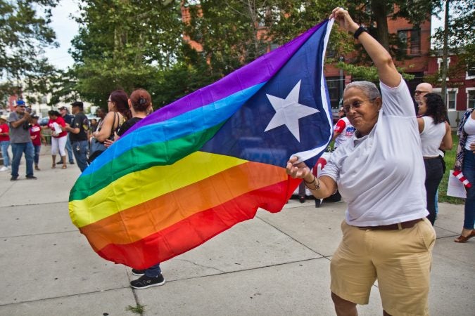 Marilyn Torres, an activist and member of Philadelphia’s Puerto Rican community celebrates the resignation of Puerto Rican governor Ricardo Rosselló at Fairhill Square in Kensington. (Kimberly Paynter/WHYY)