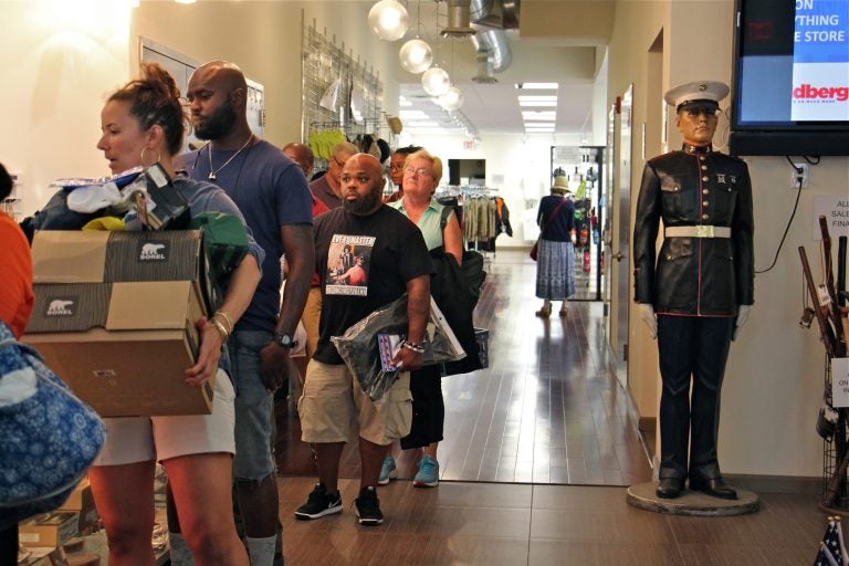 Shoppers line up at check out at I. Goldberg, which will close on Friday after 100 years in Philadelphia. (Emma Lee/WHYY)