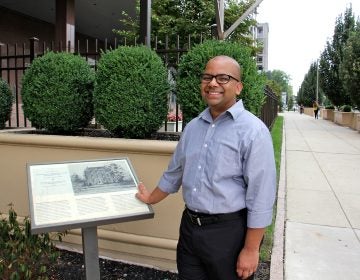 Samip Mallik, director and co-founder of the South Asian American Digital Archive, stands at 6th and Arch streets, the former site of the Female Medical College of Pennsylvania. (Emma Lee/WHYY)