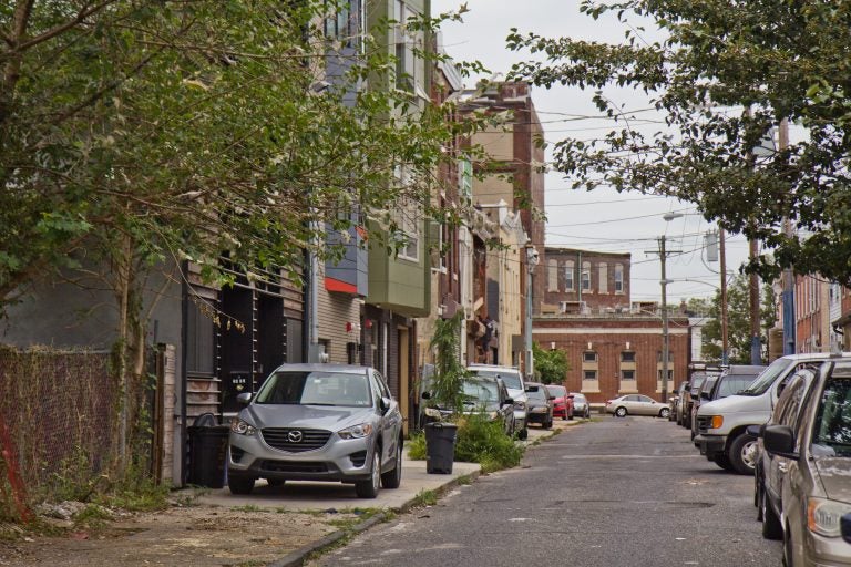 Cars are parked on the sidewalk on Fletcher Street in Philadelphia’s East Kensington neighborhood.