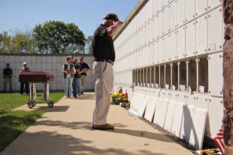 Al Duncan of Malvern, a member of the Chester County Vietnam Veterans of America, salutes after placing the remains of Eugene Gorski in a niche at Washington Crossing National Cemetery. (Emma Lee/WHYY)