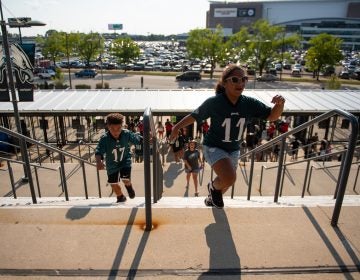 Isaac and Jazzy Dyer, from Harrisburg, Pa., run up the steps to Lincoln Financial Field before the start of open practice on Sunday, August 4, 2019. (Kriston Jae Bethel for WHYY)