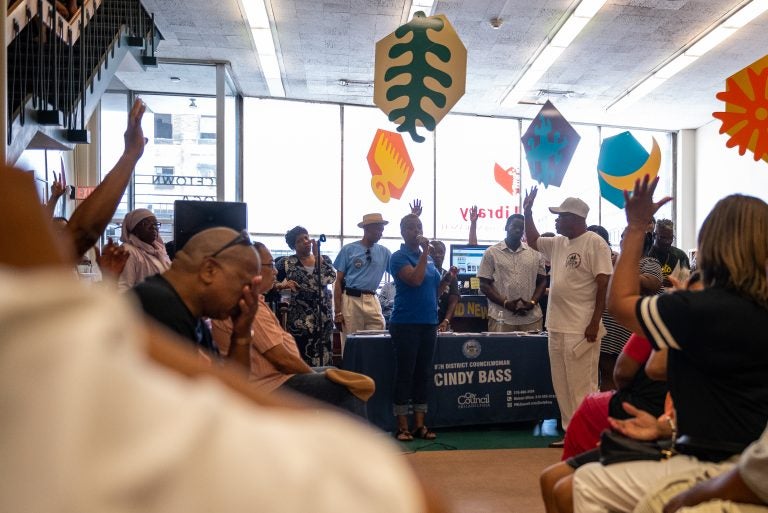 Hands are raised in response to Councilwoman Cindy Bass asking people who has experienced gun violence during a community meeting at the Nicetown-Tioga Library on Saturday, August 17, 2019. (Kriston Jae Bethel for WHYY)