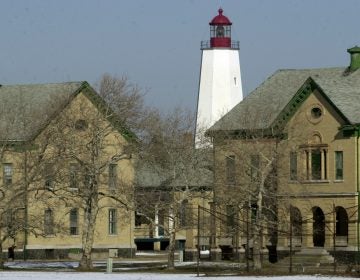 The Sandy Hook lighthouse, first built in 1764, stands Jan. 22, 2002, behind buildings that were once part of the Army's Fort Hancock, located on Sandy Hook, N.J. (Mike Derer/AP Photo)