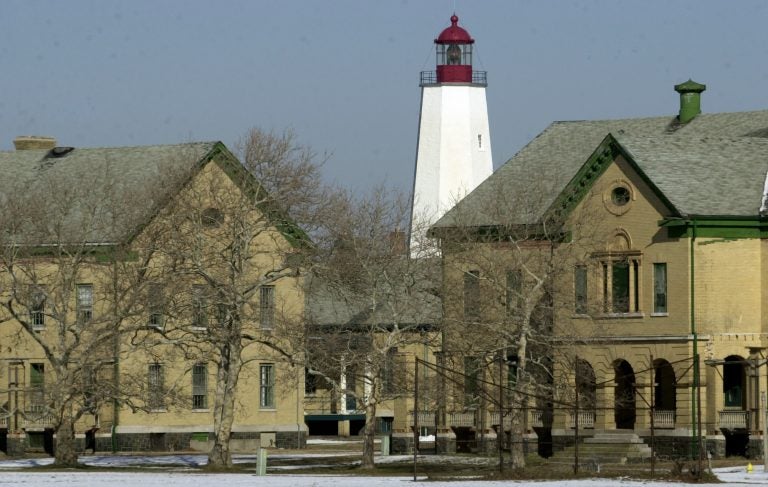 The Sandy Hook lighthouse, first built in 1764, stands Jan. 22, 2002, behind buildings that were once part of the Army's Fort Hancock, located on Sandy Hook, N.J. (Mike Derer/AP Photo)