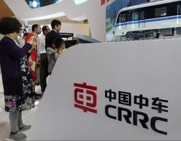 People visit the stand of CRRC (China Railway Rolling Stock Corp) during an expo in Shanghai, China, 14 June 2018. (Imaginechina via AP Images)