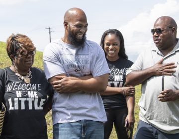 John Miller, (center), smiles with his family, Velma Miller, (left), mother, Kalita Miller, sister, and brother Lamont Washington, outside the SCI Mahanoy State Correctional Institution in Frackville, Pa. Wednesday, July 31, 2019.  Miller spent more than two decades behind bars for a murder he didn't commit, is a free man. (Jose F. Moreno/The Philadelphia Inquirer via AP)