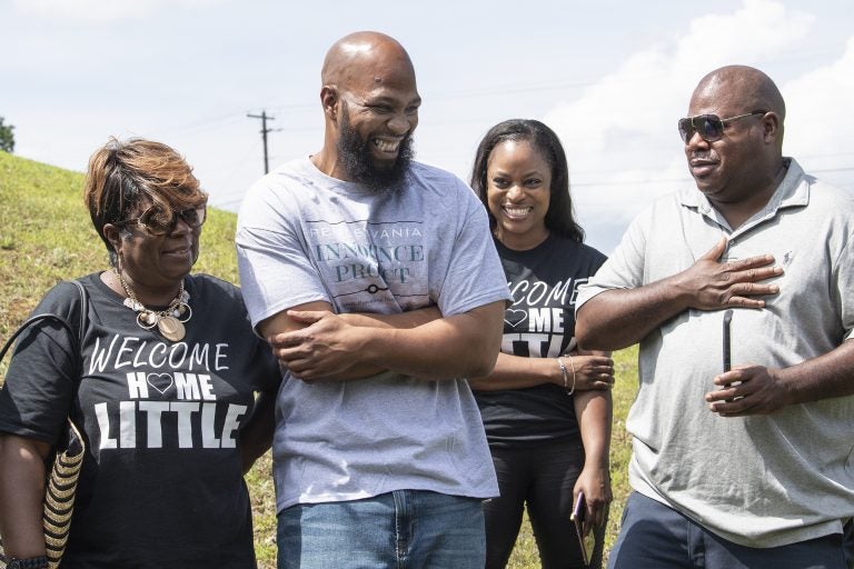 John Miller, (center), smiles with his family, Velma Miller, (left), mother, Kalita Miller, sister, and brother Lamont Washington, outside the SCI Mahanoy State Correctional Institution in Frackville, Pa. Wednesday, July 31, 2019.  Miller spent more than two decades behind bars for a murder he didn't commit, is a free man. (Jose F. Moreno/The Philadelphia Inquirer via AP)