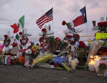 Flags fly over crosses at a makeshift memorial near the scene of a mass shooting at a shopping complex Tuesday, Aug. 6, 2019, in El Paso, Texas. (AP Photo/John Locher)