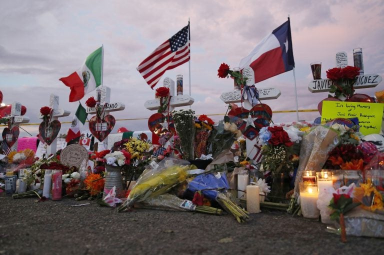 Flags fly over crosses at a makeshift memorial near the scene of a mass shooting at a shopping complex Tuesday, Aug. 6, 2019, in El Paso, Texas. (AP Photo/John Locher)