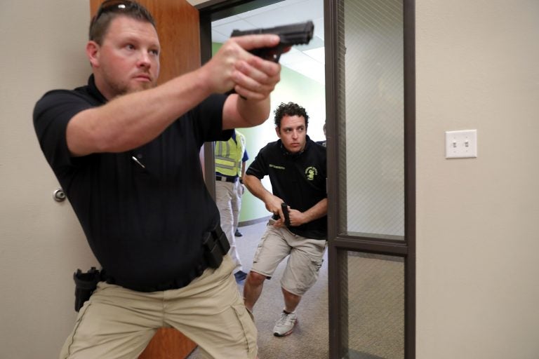 In this July 21, 2019 photo, Trainees Chris Graves, left, and Bryan Hetherington, right, participate in a security training session at Fellowship of the Parks campus in Haslet, Texas. (Tony Gutierrez/AP Photo)