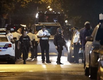 Police remain on the scene after a gunman was apprehended following a standoff Thursday, Aug. 15, 2019, in Philadelphia. A gunman who opened fire on police Wednesday as they were serving a drug warrant in Philadelphia, wounding several officers and triggering a standoff that extended into the night, is in police custody, authorities said. (AP Photo/Matt Rourke)