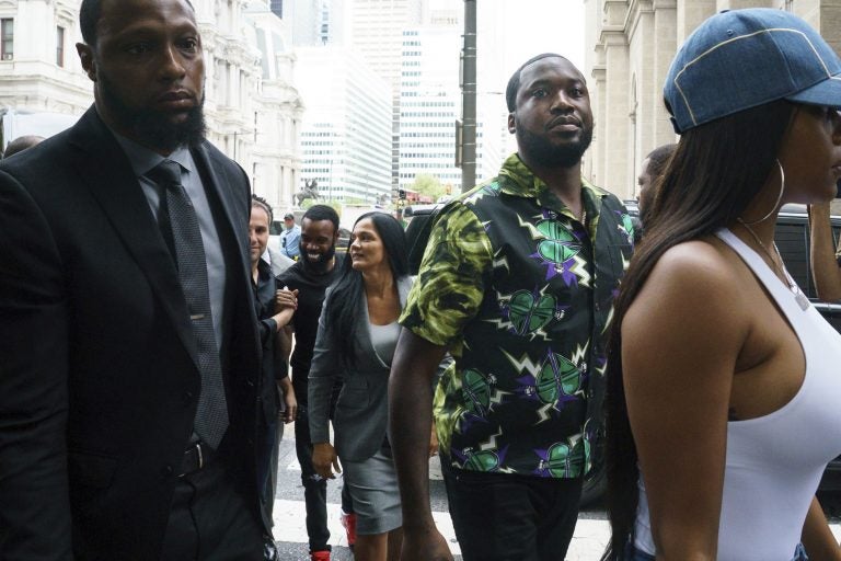 Rapper Meek Mill, (center), arrives at the Criminal Justice Center in Philadelphia on Tuesday, Aug. 27, 2019.  (Jessica Griffin/The Philadelphia Inquirer via AP)