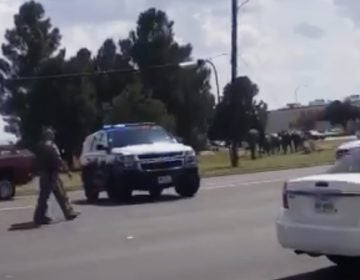 In this image made from video provided by Dustin Fawcett, police officers guard on a street in Odessa, Texas, Saturday, Aug. 31, 2019. Police said there are 