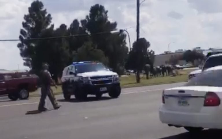 In this image made from video provided by Dustin Fawcett, police officers guard on a street in Odessa, Texas, Saturday, Aug. 31, 2019. Police said there are 