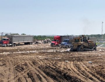 A view of trucks on a landfill