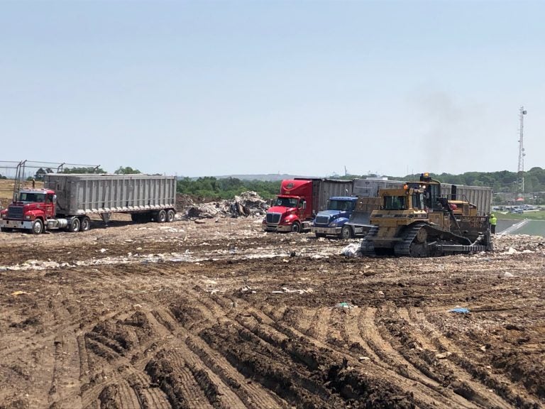 A view of trucks on a landfill