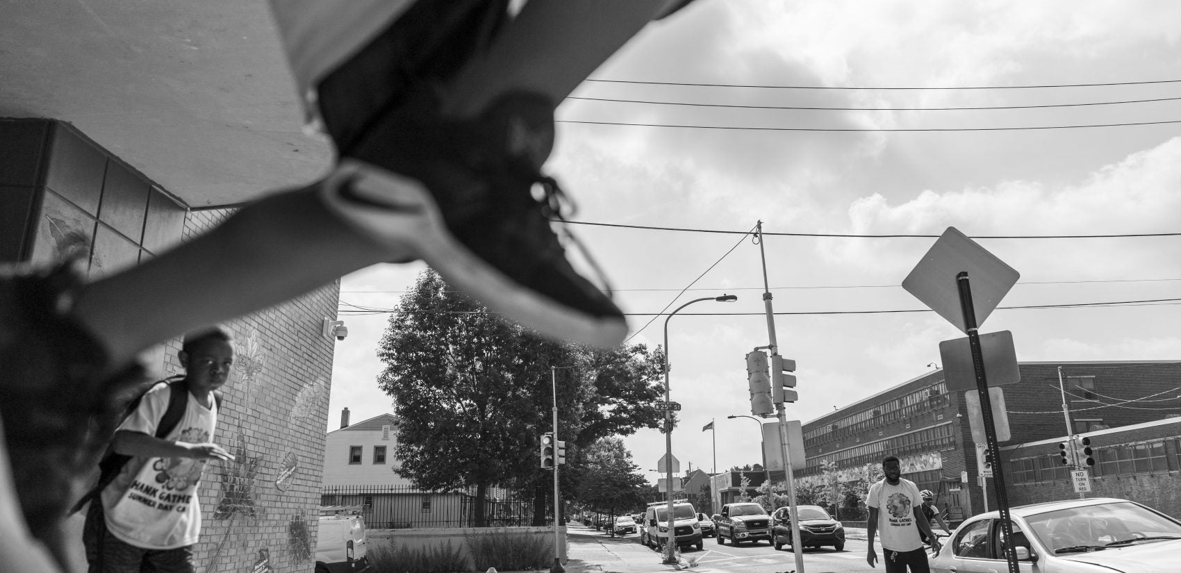 As a young boy ascends from the stoop outside the Hank Gathers Rec Center. Across the street sits William Dick Elementary. (Jessica Kourkounis for Keystone Crossroads)