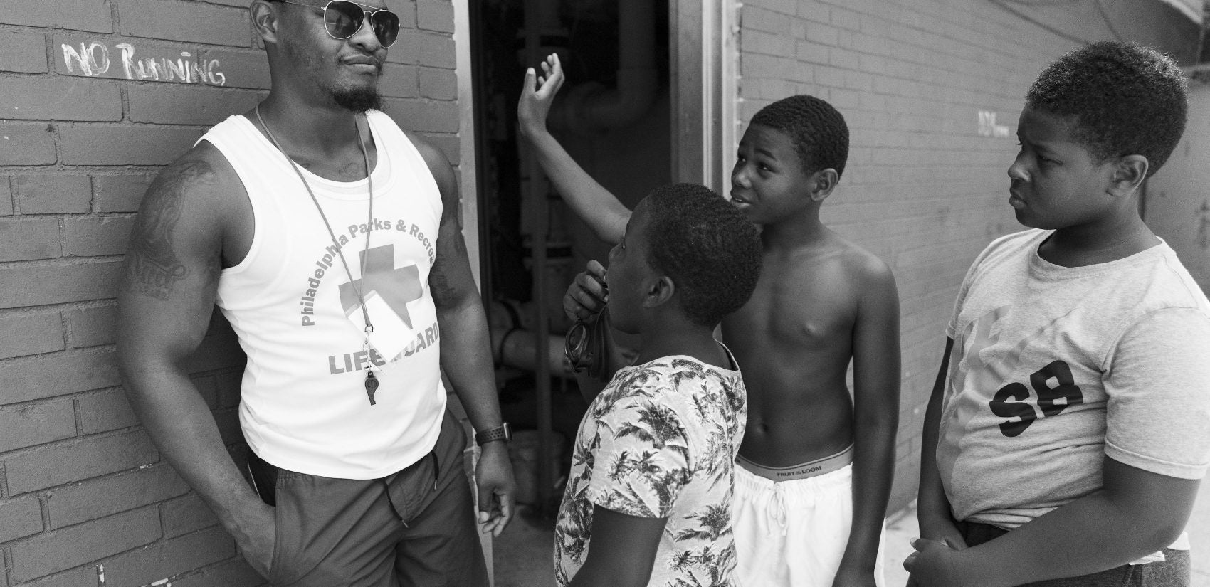 Gathers' head lifeguard Howard Bolden, 22, talks to kids on the pool deck. 