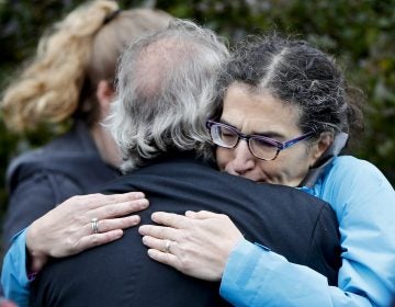 People embrace along the street in the Squirrel Hill neighborhood of Pittsburgh where a shooter opened fire during services at the Tree of Life Synagogue on Saturday, Oct. 27, 2018. (Keith Srakocic/AP Photo)