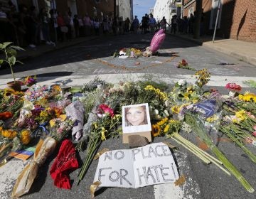 A makeshift memorial of flowers and a photo of victim Heather Heyer sits in Charlottesville, Va., on Aug. 13, 2017. Heyer died when a car rammed into a group of people who were protesting white supremacists who had gathered in the city for a rally. (Steve Helber/AP Photo)