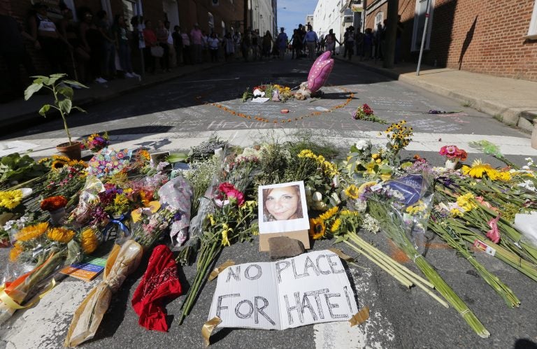 A makeshift memorial of flowers and a photo of victim Heather Heyer sits in Charlottesville, Va., on Aug. 13, 2017. Heyer died when a car rammed into a group of people who were protesting white supremacists who had gathered in the city for a rally. (Steve Helber/AP Photo)