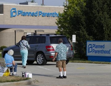 Abortion protesters attempt to hand out literature as they stand in the driveway of a Planned Parenthood clinic in Indianapolis on Aug. 16.