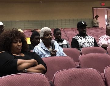 A woman who lives near the Croda chemical plant questions company and state officials during a meeting about November’s toxic release and steps being taken before the plant can resume making ethylene oxide. (Cris Barrish/WHYY)