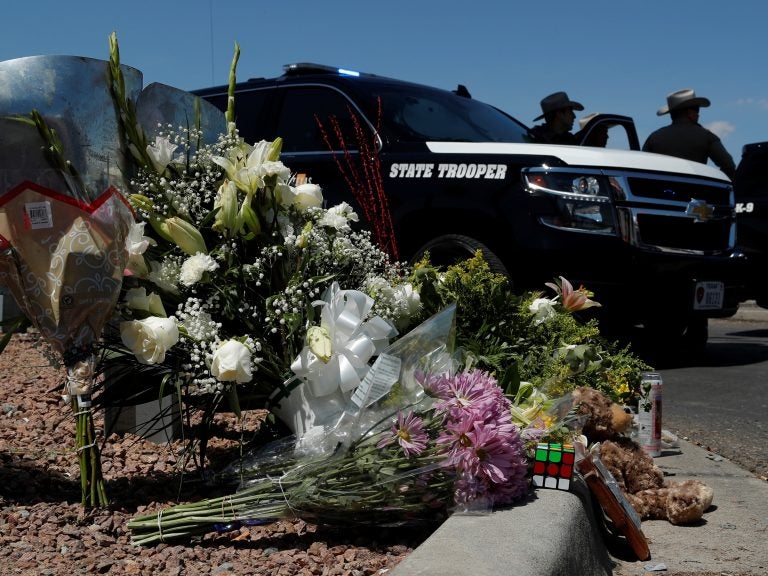 Flowers adorn a makeshift memorial near the scene of a mass shooting at a shopping complex Sunday in El Paso, Texas. (John Locher/AP Photo)