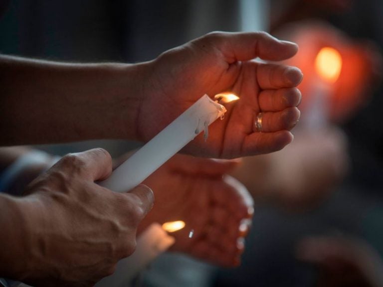People light candles during a prayer and candle vigil organized by the city, after the recent shooting at a WalMart in El Paso, Texas.
(Mark Ralston/AFP/Getty Images)