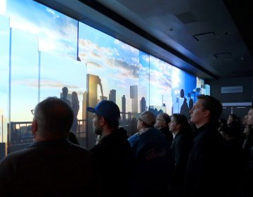 At One World Trade Center in 2017, visitors watch a movie at the New York City building's observatory. Now there's a new feature: A scent meant to complement the multimedia experience. (Gary Hershorn/Getty Images)